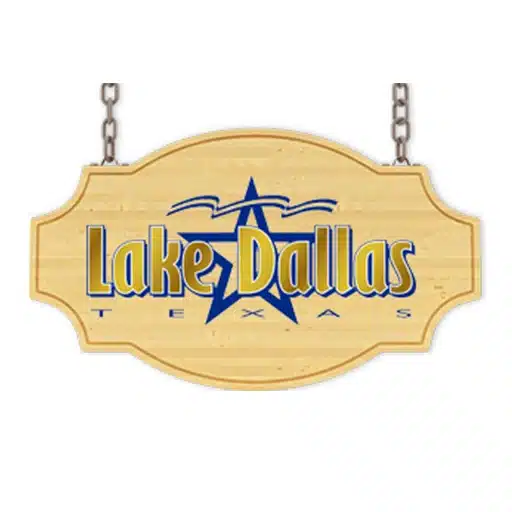 Wooden sign with chains displaying "Lake Dallas Texas" in blue and yellow text, with a star design in the background.
