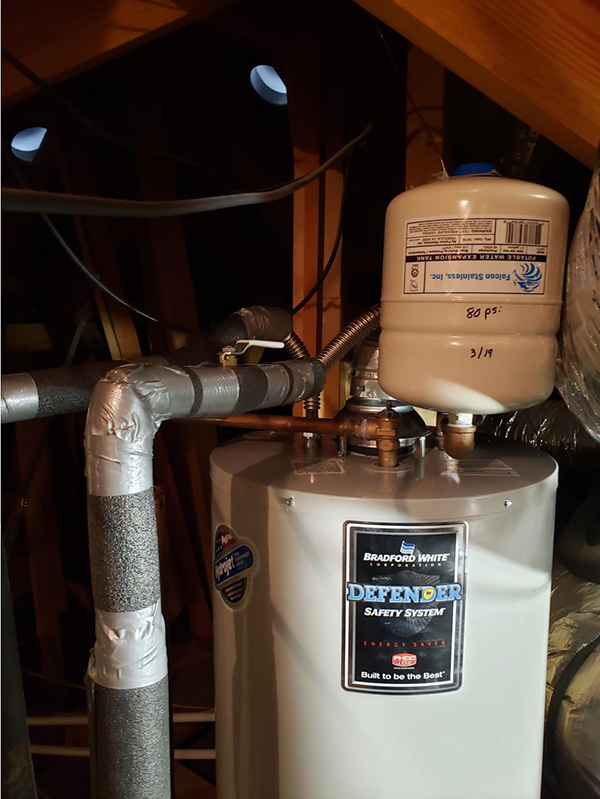 Trident Plumbing photo of water heater with Expansion Tank on it in the attic